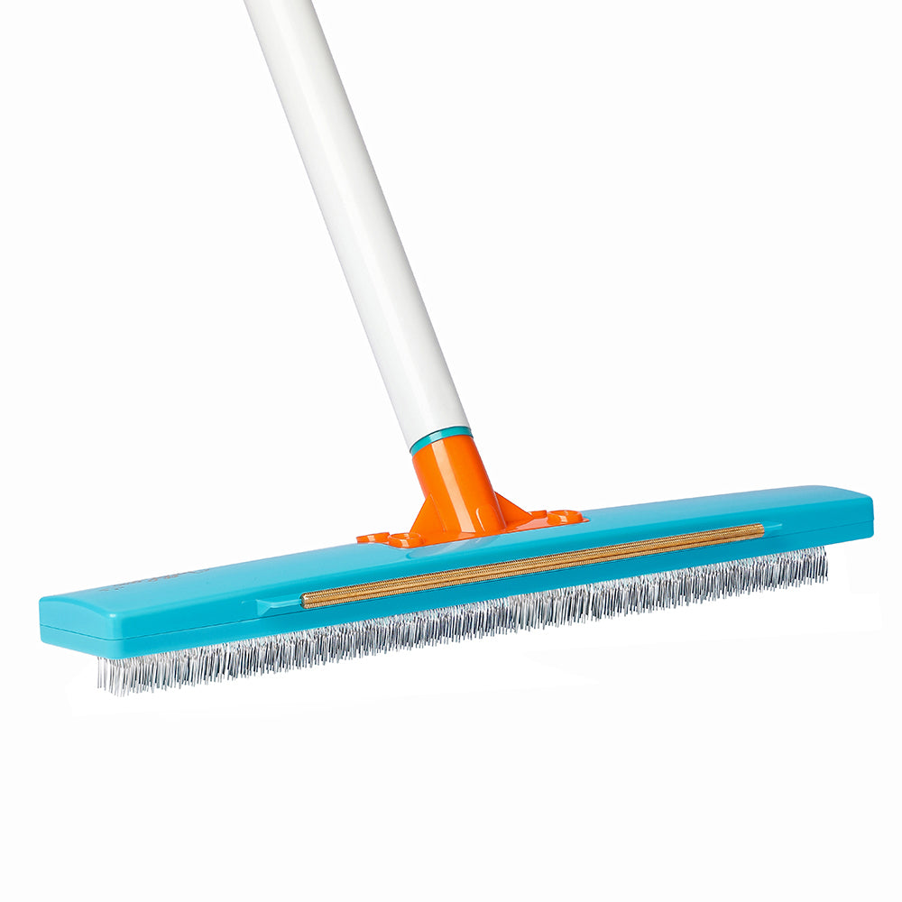 Close-up of the Jolllax 2-in-1 Carpet Rake head showing the brass scraper and steel pin brush for deep carpet cleaning.